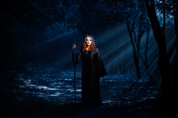 Witch in night forest