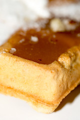 Waffles topped with cream and grounded biscuits