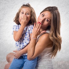 Mother and daughter doing surprise gesture