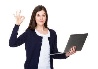 Woman hold with laptop computer and ok sign gesture