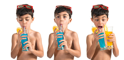 Child drinking blue beverage © luismolinero