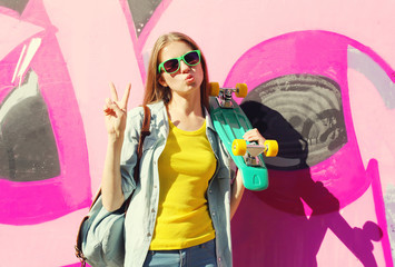 Fashion pretty cool girl wearing a sunglasses and skateboard hav