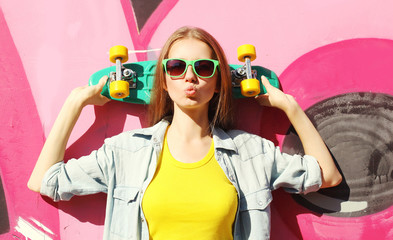 Fashion pretty cool girl wearing a sunglasses and skateboard hav