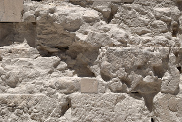 The white walls of limestone marble in the ancient Acropolis of Athens.