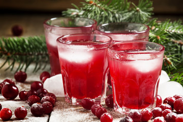 Christmas cranberry cocktail with ice, decorated with fir branch
