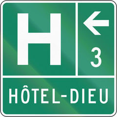 Guide sign in Quebec, Canada - Hospital on the left. The text means hospital