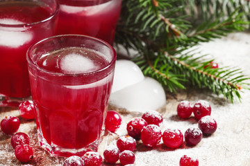 Christmas cranberry cocktail with ice, decorated with fir branch