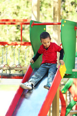 Little boy playing on the children playground