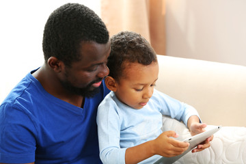 Father and son on sofa in the room