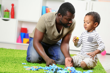 Father and son paying in the children room