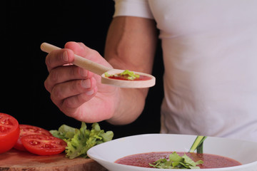 Close up on man man cooking tomato soup, spaghetti sauce. Cooling at home, healthy lifestyle, diet food