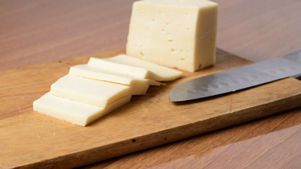 Cut cheese on a wooden board