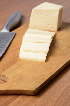 Cut cheese on a wooden board