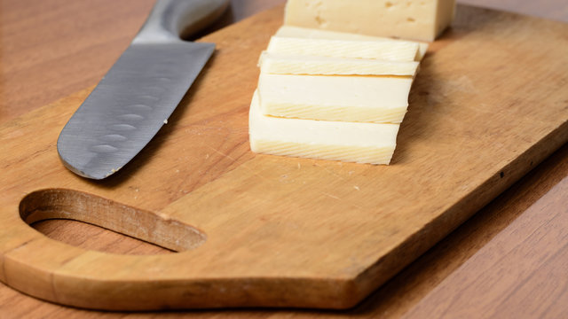 Cut cheese on a wooden board