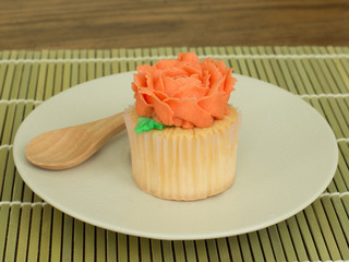 homemade beautiful rose cupcake on the placemats.