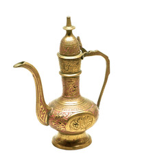 Old golden metallic kettle with ethnic ornaments