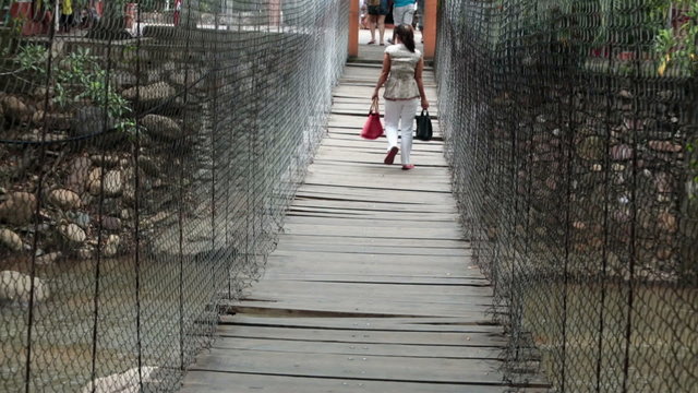 Woman walks across dangerous suspension bridge Mexico HD 3674