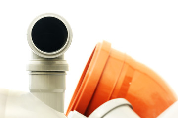 Composition from plastic sewer pipes on a white background