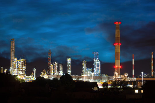 Petrochemical plant at night time with the reflection on the water.