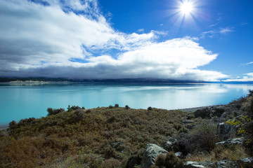 Fototapeta na wymiar Lake Pukaki is fed from melting of the Tasman and Hooker Glaciers. The Lake has a distinctive blue color, that is caused by glacial flour, fine rock particles from the glaciers.