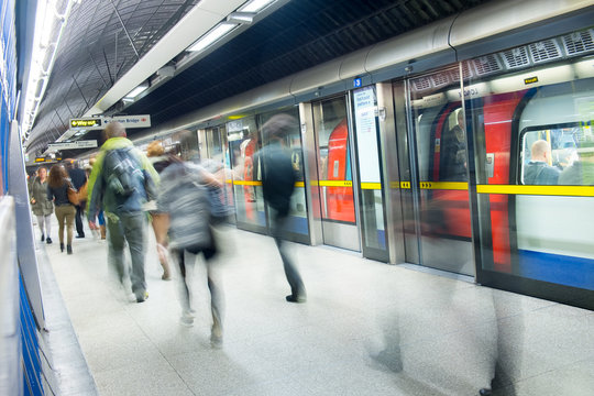 Travelers movement in tube train station, London..