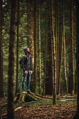 Fototapeta premium Hooded man posing in the forest