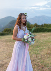 Attractive bride is holding a wedding bouquet