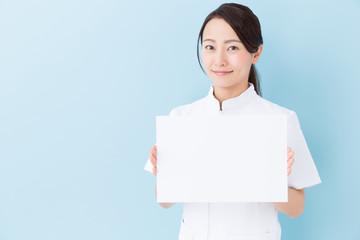 portrait of asian nurse on blue background