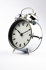 Alarm clock with sticky paper note on white background