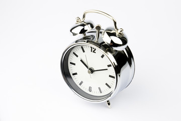 Alarm clock with sticky paper note on white background