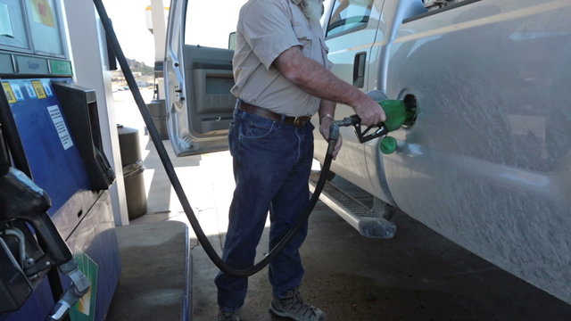 Man filling pickup truck with gas HD 3525