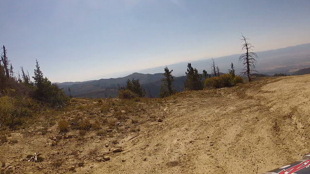 Riding ATV to edge of mountain valley overlook HD 008