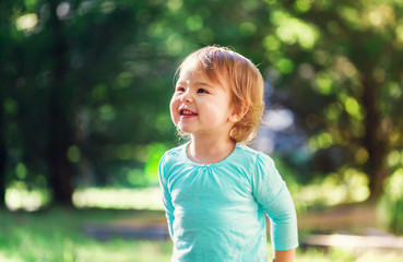 Fototapeta premium Happy toddler girl smiling outside