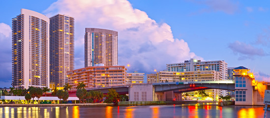 Hallandale Beach Florida, modern buildings and colorful illuminated bridge at sunset - 93736648