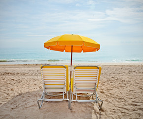 Lounge chairs and colorful umbrellas at the beach in Miami FLorida