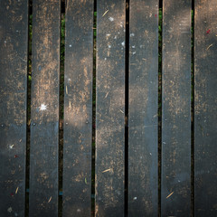 old wooden walkway with falling leaves in the morning of autumn