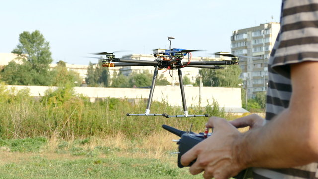 
Pilot's hands with  radio transmitter,  operate of drone with eight propeller .4K 3840x2160
