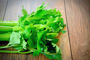 Fresh Juicy Celery on Woody Background