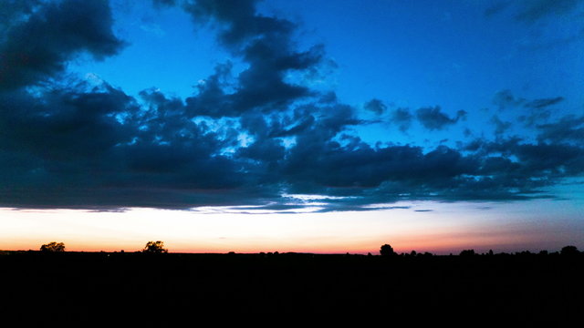 
Nightfall with beautiful clouds and  dark earth. 4K 4096x2304 . Without birds
