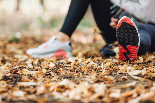 Runner Woman Rest On The Leaves In Park