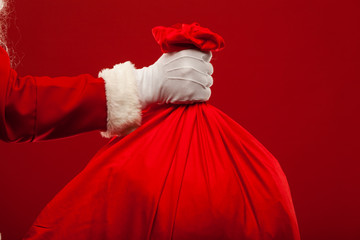 santa claus with big bag on shoulder glasses  red background