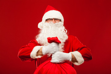 santa claus with big bag on shoulder glasses  red background