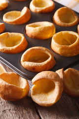 Yorkshire puddings in baking dish close up on the table. Vertical
