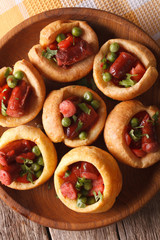 Yorkshire pudding with sausages and vegetables closeup. vertical top view
