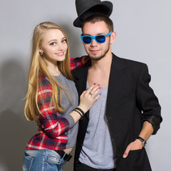 fashion portrait of beautiful couple together. Hipster boy and girl.