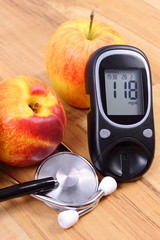 Glucose meter with medical stethoscope and fresh fruits, healthy lifestyle