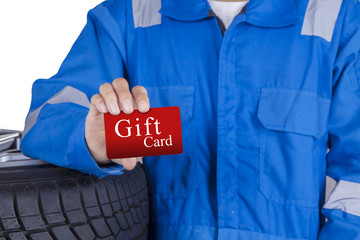 Male mechanic showing gift card