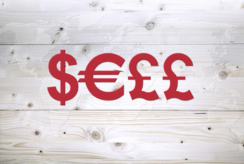 International red currency units say SELL on world map wooden background