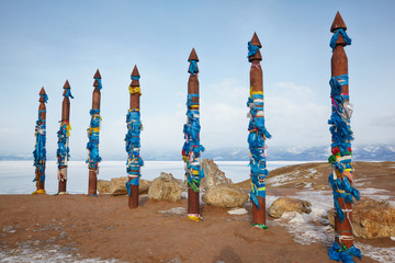 Wooden shaman totems with ribbons
