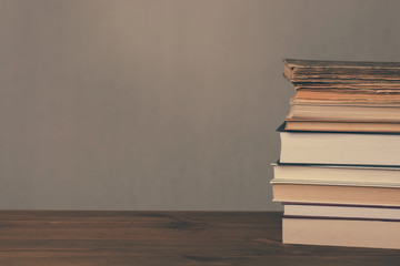 Books on wooden table and grunge background